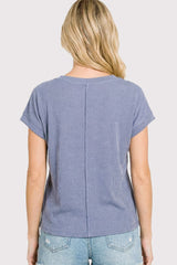 woman wearing a blue striped short sleeve top with a relaxed fit and back seam detail, seen from the back