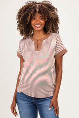 woman wearing a brown and beige striped maternity top with a slight v-neck and short sleeves, smiling at the camera