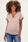 woman wearing a brown and beige striped maternity top with a slight v-neck and short sleeves, smiling at the camera