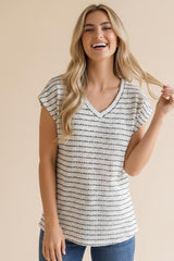 woman wearing a light gray striped short sleeve top with a v-neck and casual style