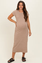 woman wearing a light brown maternity maxi dress with short sleeves and a visible baby bump