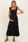 woman wearing a black ruffle strap maternity maxi dress and holding her baby bump