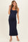 woman wearing a navy blue maternity maxi dress with a fitted silhouette and a visible baby bump
