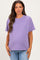 woman wearing a light purple short sleeve maternity top and showing her baby bump