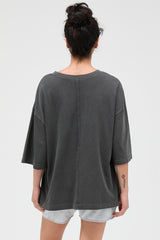 woman wearing a loose-fitting dark grey oversized t-shirt with a back seam detail
