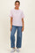 woman wearing a light pink short sleeve t-shirt and high-waisted wide-leg jeans with white sneakers