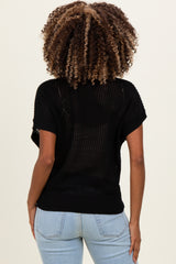 woman wearing a black knitted maternity top with short sleeves and a loose fit, showing her back