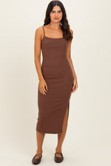 woman wearing a brown ribbed sleeveless midi dress with a side slit and spaghetti straps