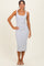 woman wearing a light gray sleeveless midi dress with a square neckline and a fitted silhouette