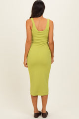 woman wearing a fitted lime green ribbed midi dress, seen from the back, with a scoop neck and sleeveless design