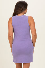 woman wearing a lavender sleeveless maternity dress, showing the back view