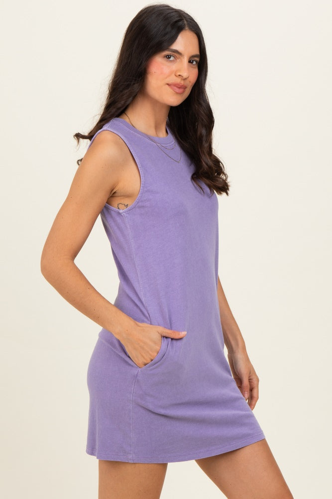 woman wearing a lavender sleeveless mini dress with side pockets and a relaxed fit