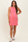 woman wearing a pink sleeveless maternity dress with pockets and a rounded neckline, baby bump visible