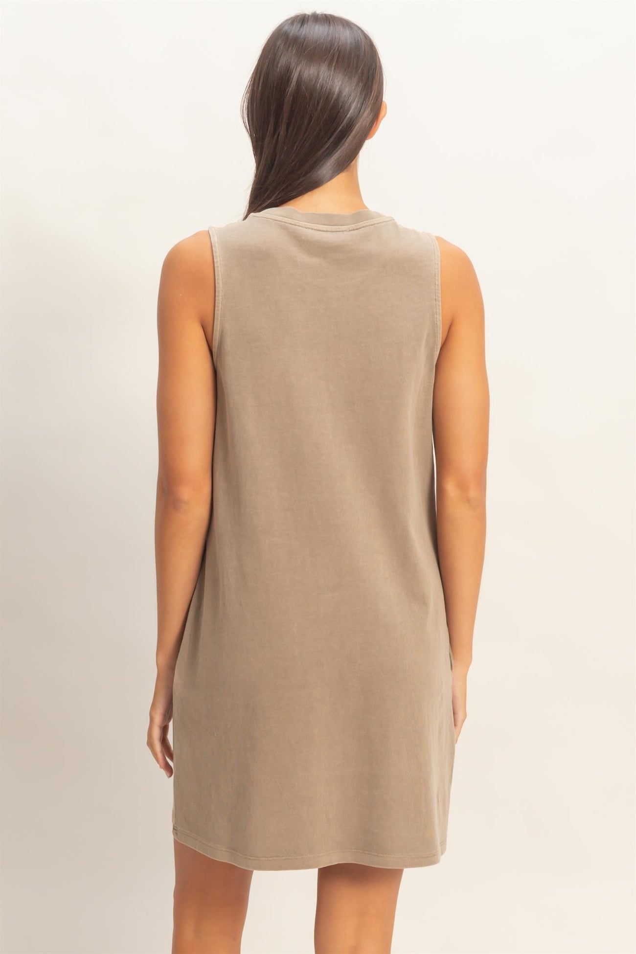 woman wearing a taupe sleeveless casual dress from the back