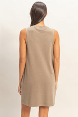 woman wearing a taupe sleeveless casual dress from the back