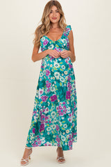 woman wearing a floral maternity maxi dress with ruffle straps and a baby bump visible