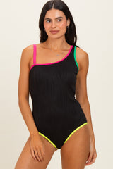 woman wearing a black one-shoulder swimsuit with colorful straps in pink, green, and yellow