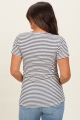 woman wearing a striped maternity short sleeve top, viewed from the back, paired with blue jeans