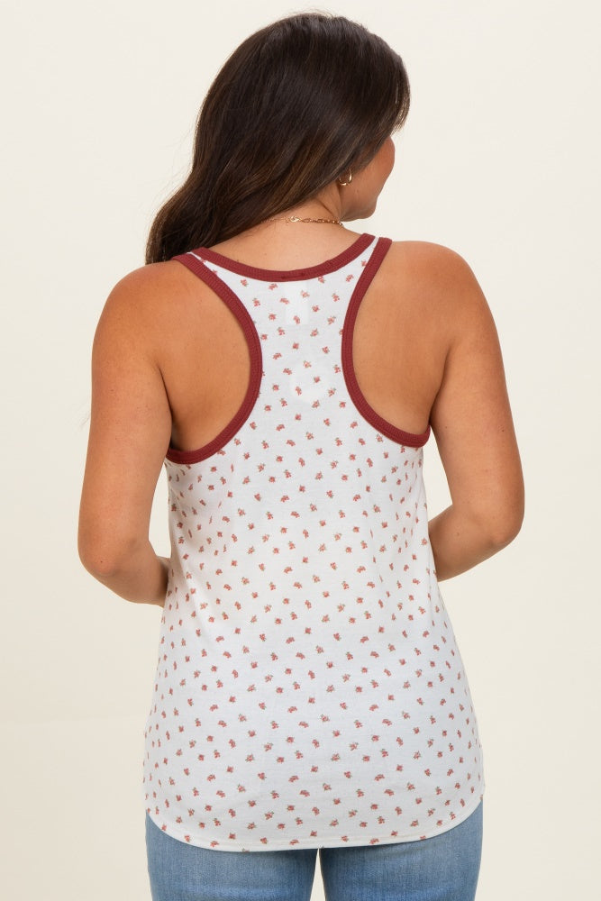 woman wearing a light gray maternity tank top with maroon trim and small floral print on the back