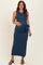 woman wearing a navy blue sleeveless maternity maxi dress with a side tie and holding her baby bump