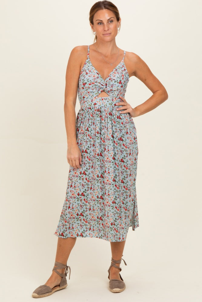 woman wearing a floral midi dress with a tie front and spaghetti straps