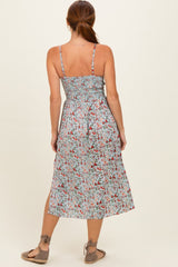 woman wearing a back view of a floral midi dress with thin straps and a smocked bodice