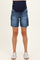 woman wearing dark blue maternity denim shorts with a high waistband and side pockets, styled with sneakers