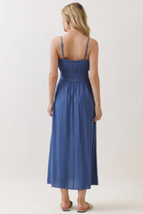 woman wearing a back view of a blue maxi dress with adjustable straps and a smocked bodice