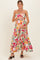 woman wearing a floral maternity maxi dress with a tiered skirt and holding her baby bump