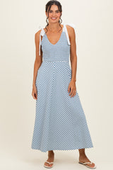 woman wearing a blue and white striped maxi dress with tie shoulder straps and a fitted bodice