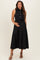 woman wearing a black sleeveless maternity dress with a tie around the waist and button details, holding her baby bump
