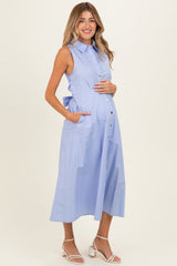 woman wearing a light blue sleeveless maternity dress with a button-down front and pockets, showing her baby bump