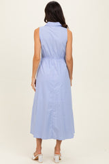 woman wearing a light blue sleeveless maxi dress with a collar and belted waist, viewed from the back