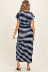 woman wearing a navy and white striped maternity maxi dress with short sleeves and a tie detail at the waist