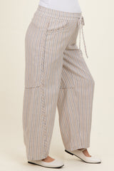 woman wearing beige and white striped maternity wide-leg pants with a drawstring waist