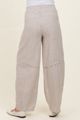 woman wearing light beige striped maternity pants with wide legs, showing the back view