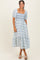 woman wearing a blue and white floral smocked midi dress with puff sleeves and a square neckline