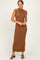 woman wearing a brown ribbed knit sleeveless maxi dress with a high neckline and a fitted silhouette
