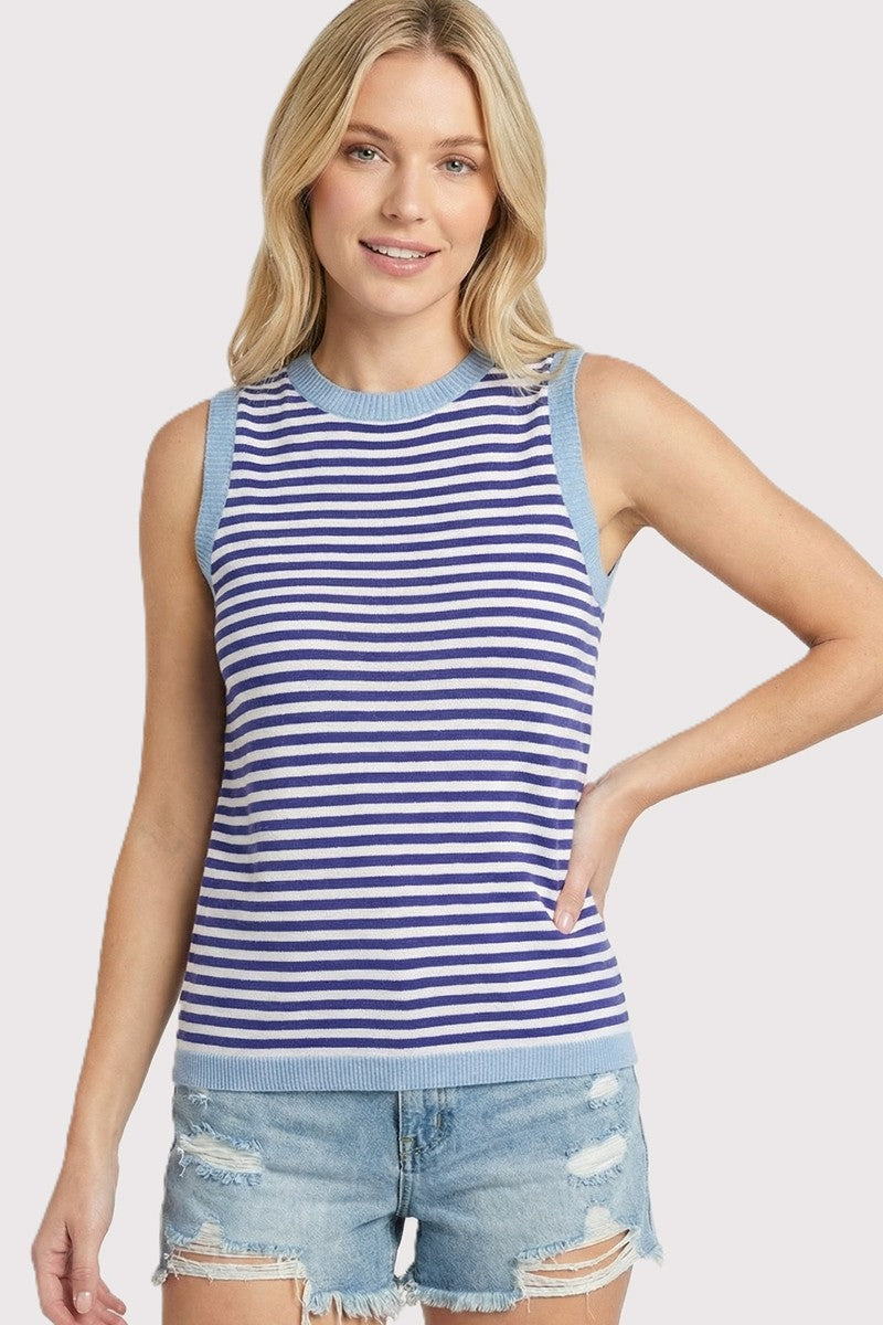 woman wearing a blue and white striped sleeveless top with light blue trim and distressed denim shorts