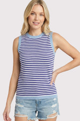woman wearing a blue and white striped sleeveless top with light blue trim and distressed denim shorts