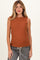 woman wearing a rust colored sleeveless maternity top with a relaxed fit and a round neckline