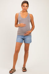 woman wearing a gray ribbed tank top and denim shorts, showing her baby bump
