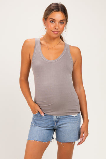 woman wearing a light gray maternity tank top with a scoop neck and paired with denim shorts