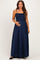 woman wearing a navy blue smocked maternity maxi dress and holding her baby bump