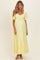 woman wearing a light yellow maternity maxi dress with short flutter sleeves and a gathered bust, showcasing a baby bump