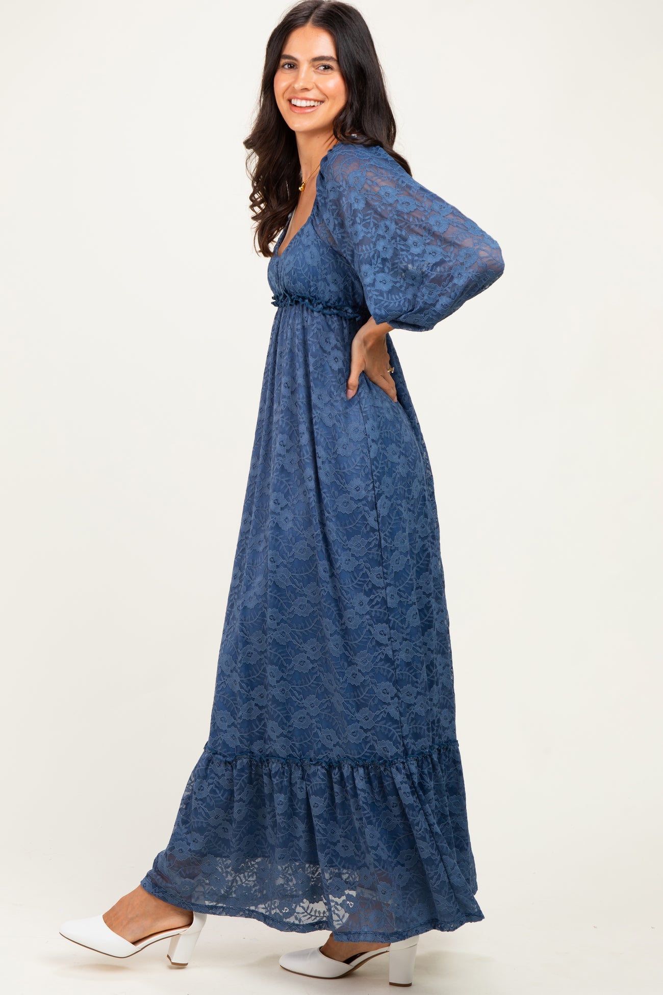 woman wearing a blue lace maxi dress with balloon sleeves and a ruffled hem