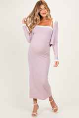 woman wearing a lavender long sleeve maternity dress with white trim and holding her baby bump