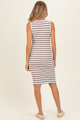 woman wearing a gray and white striped maternity dress, viewed from the back, with a fitted style and knee-length cut
