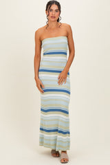 woman wearing a strapless multi-striped maxi dress in light blue and green hues with a bodycon fit
