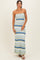 woman wearing a strapless multi-striped maxi dress in light blue and green hues with a bodycon fit